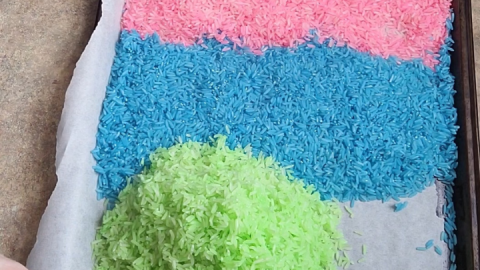 Colored rice on a wax paper lined cookie sheet.