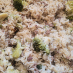 Up close photo of cooked rice broccoli and ground beef all in one pot.