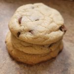 Three stacked chocolate chip cookies