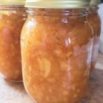 three jars of Apple Pie Jam In a Jar On the Counter.